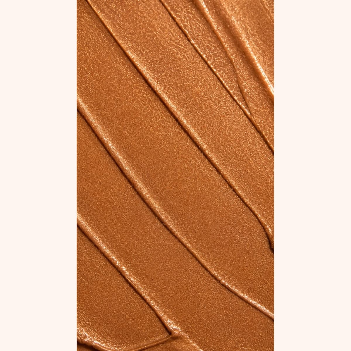 Close-up smear of Bronze Glow Body Shimmer texture