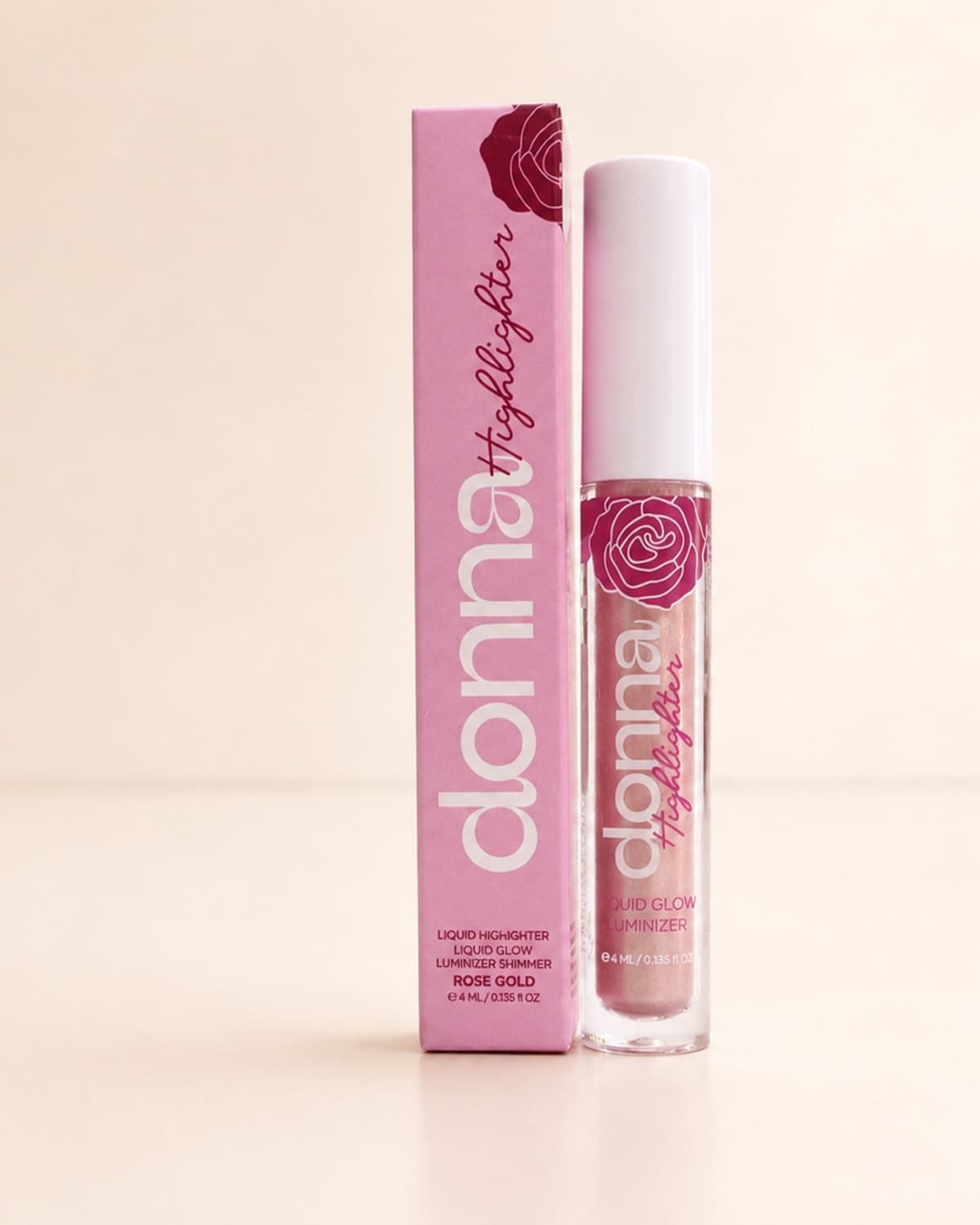 هايلايتر دونا السائل بدرجة Rose Gold بجانب علبته